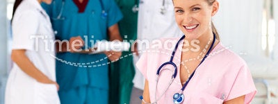 Blonde nurse with her team in the background