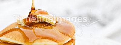 Syrup Pouring onto a Stack of Pancakes