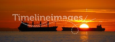 Cargo ships at sunset