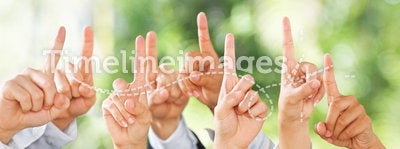 People raise their hands up over green background