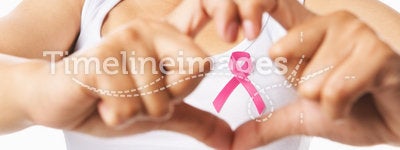 Heart framing on woman chest with pink badge