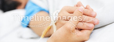 Holding patient hand in hospital