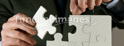 Businessman Making A Puzzle