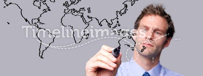 Businessman drawing the world map on a glass scree