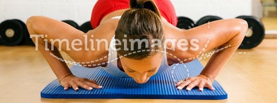 Woman doing pushups in gym