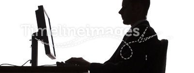 Silhouette of man working computer