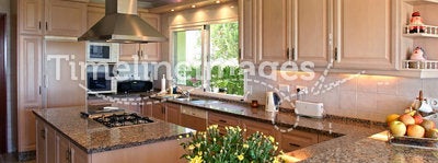 Kitchen interior of large spanish villa. With fresh flowers and fruit
