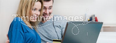 Smiling surprised couple online shopping