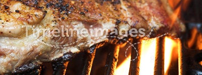 Flaming barbecue ribs on a grill
