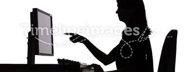 Silhouette of woman working computer - pointing screen