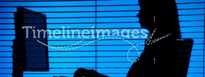 Silhouette of woman working computer (blind)