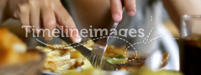 Woman with knife and fork