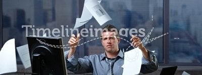 Businessman throwing documents into air