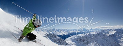 Skier with sun and mountains