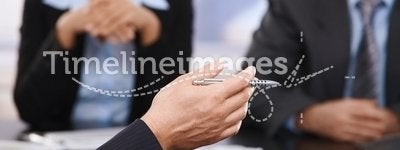 Business meeting, hand with pen in closeup