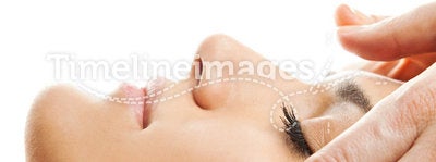Facial massage isolated. Profile close-up of a beautiful woman face receiving massage isolated