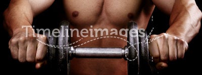 Powerful muscular man holding workout weight
