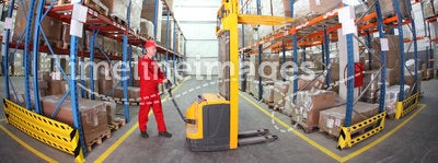 warehousing - manual forklift operator at work in