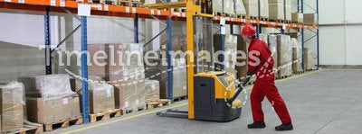 Worker in red uniform at work in warehouse