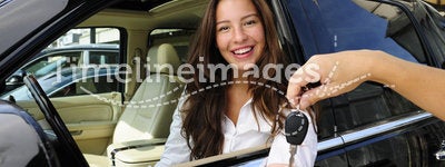 Businesswoman receiving keys of new car