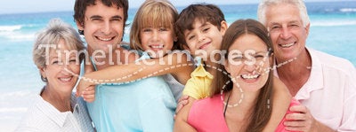 Three Generation Family Relaxing On Beach
