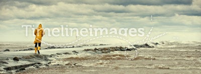Person walking by stormy sea