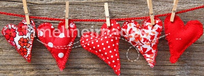 Red hearts hanging on line