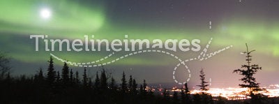 Full Moon and active colorful aurora over Fairbanks Alaska