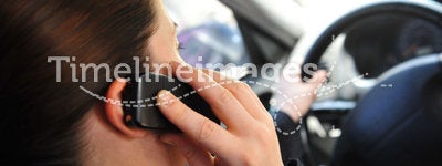Woman in a car talking on a phone