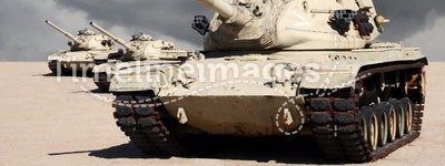 Three Army War Tanks in Desert