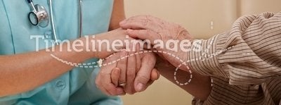 Hands of nurse and elderly patient.