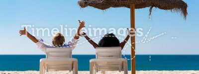 Couple on beach vacation with sunshade