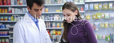 Pharmacist advising client at pharmacy