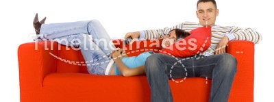 Comfortable Man And Woman On Orange Couch With Remote