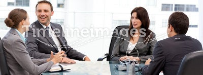 Handsome manager laughing during a meeting