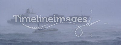 Ship in a Storm. A large cargo ship leaves the harbor at Flushing (Vlissingen), the Netherlands in a heavy storm