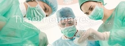 Surgeons and medical assistant operating
