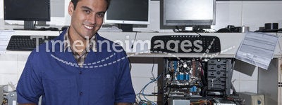 Computer technician with motherboard at workshop