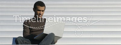 College Age Student Studies from Laptop