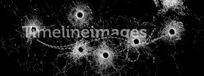 Broken glass - bullet holes isolated on black