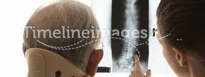 Doctor showing patient x-ray.