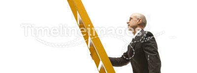 Businessman climbing ladder.