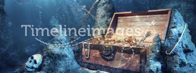 Open treasure chest with bright gold underwater