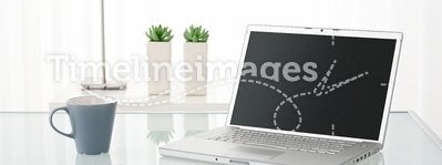 Computer, coffee mug, lamp and plants