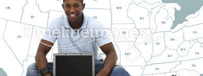 Attractive Young Man Sitting On Floor with Laptop Computer