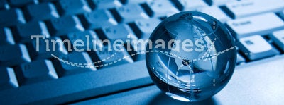 Transparent globe on a laptop keyboard