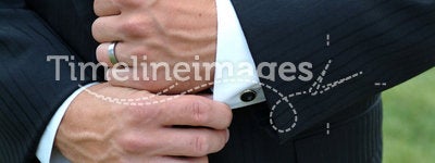 Man adjusting sleeve cuff