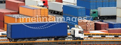 Truck carries container to warehouse near the sea