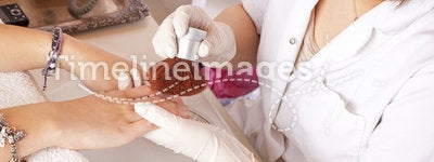 Nail designer cleaning acrylic fingernails