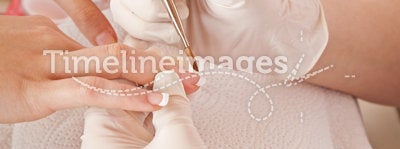 Nail designer working on acrylic fingernails